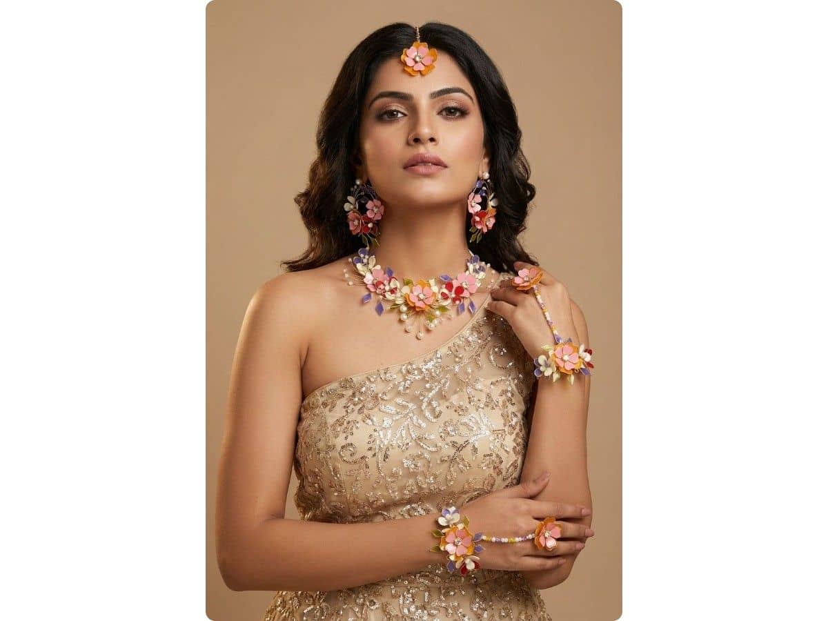 Peach pink, orange and red resin flowers with violet leaves and pearl drops on a necklace, with matching earrings, maang tikka and haathphool on both hands